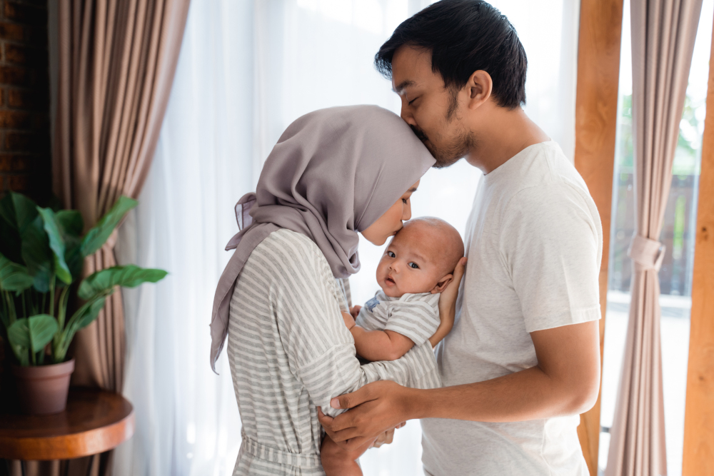 couple with baby kissing