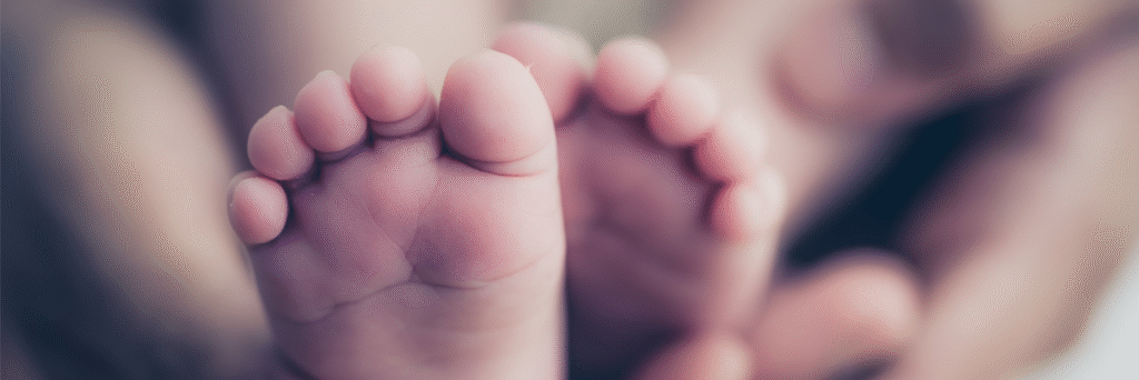 Woman holding babies feet